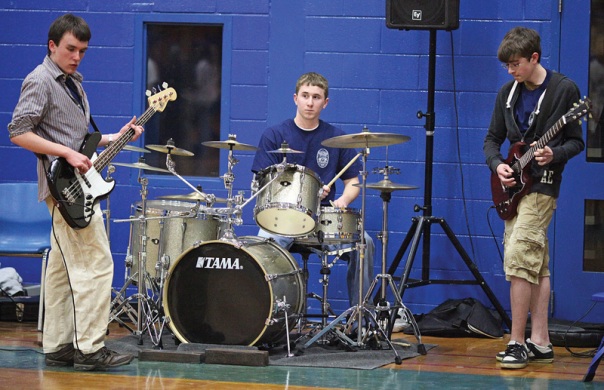 Three of the four members of Four Guys in a Dumpster, left to right, Newington High students, Aaron Carta, Dan Collin, and Matt Belliveau(lead singer Connor Hamil was off camera) perform at the fourth annual Ciara McDermott Basketball Classic at Newington High School.