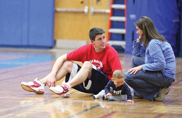 Newington High School gym teacher Steve Bennett, takes a break between games with wife Kim and 9 month old Gavin, at the fourth annual Ciara McDermott Basketball Classic at Newington High School.